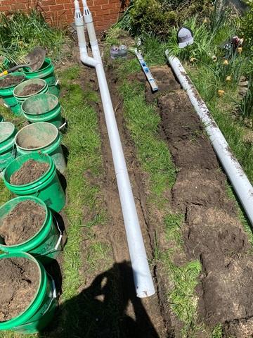 We installed an exterior discharge line in Patricia's crawlspace. It was put toward a low point in the property, sending water away from the home. Since the system is inside, there's no dirt to clog it up and water is discharged effectively via the sump pump.