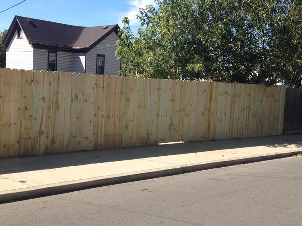 <p>Pressure treated wood fence installed in backyard.</p>