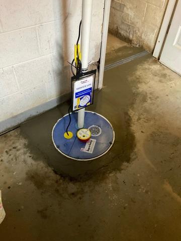 Here is the finished products of both our TrenchDrain and SuperPump installation. The drain routes any water to the sump preventing any flooding. Our SuperPump has a strong, airtight lid that keeps out any insects, odors and radon gas.