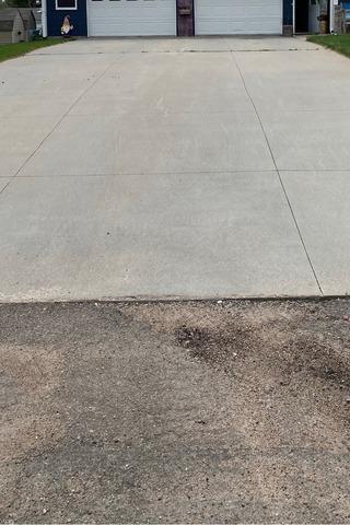 This home's driveway was sinking due to pools of water seeping in the cracks and joints of the concrete and weakening the soil underneath the concrete. This allowed the weight of the concrete to sink down on the weakened soil.