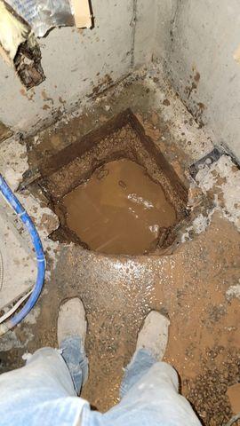 Sump location before sump is installed. No shortage of water below this slab.