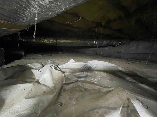 After clearing the space of rocks, workers begin to spread cleanspace throughout the area to prevent mildew, mold and other problems that could further damage the customer's crawl space.