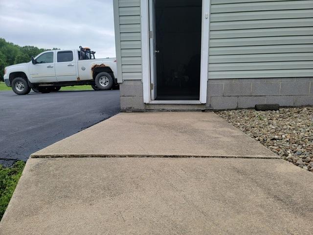 The concrete near this homeowner's garage was beginning to sink, creating a tripping hazard for the family that lives here.