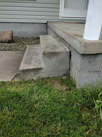 Because the concrete that makes up this walkway was beginning to sink, the steps were starting to pull away from the foundation, leaving large voids.