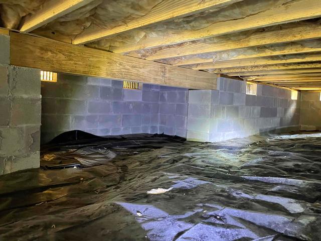 The foundation walls of this crawl space were made with porous cinderblocks, which allow moisture to seep through them and elevate the relative humidity. These walls were also lined with open vents which allow the outside air and moisture to flow freely into the crawl space and affect the environment.