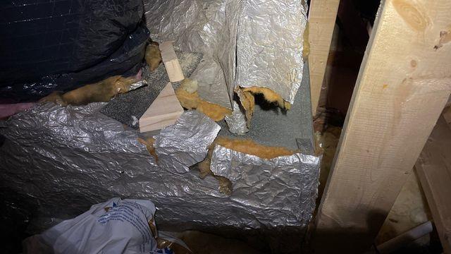 This ripped and fallen away insulation is no longer providing any service to the HVAC duct.