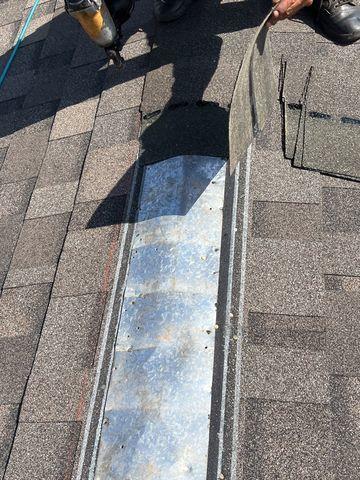 Once the ridge flashing is installed, the new shingles can be installed over it.