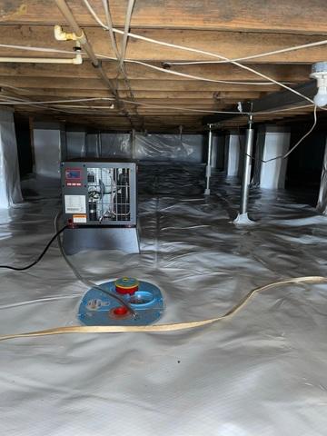 The dehumidifier (top) keeps moisture levels at about 55%. The sump pump (bottom) keeps the crawlspace nice and dry by carrying out the excess water.