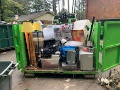 The Junkluggers of Atlanta Metro East team packs one of our cans full of stuff from our customer. Our junk haulers are excellent at packing these cans so that our customers get maximum value.
