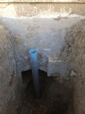 Helical pier next to foundation