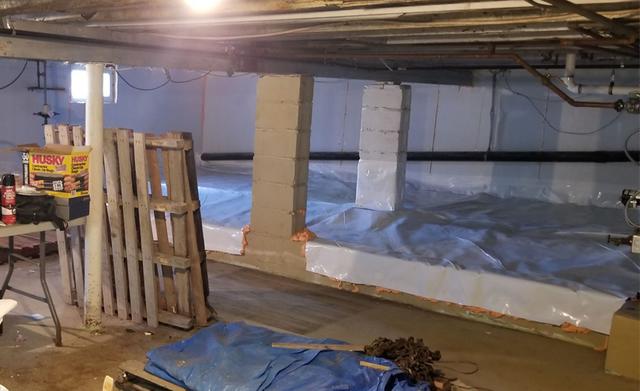 To correct the exposed earth we installed heavy duty drainage mat and 20 Mil Clean Space liner over the dirt. All seams are sealed and liner is mechanically fastened to wall and pillars. This makes the space suitable for storage without any worries of damaging the liner or moisture building up in the basement.