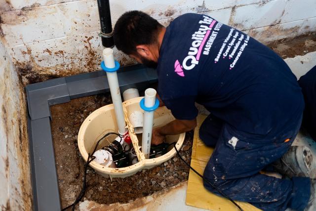 Here is an action shot of our crew member installing the TripleSafe Sump Pump System. We also see the WaterGuard French Drain installed.