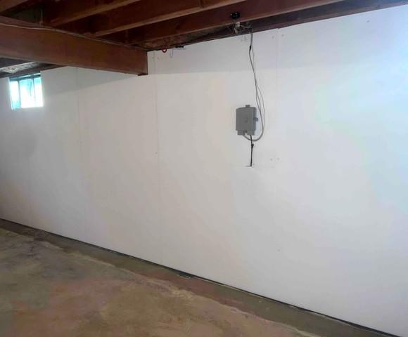 This basement had water seeping through the walls leaving discoloration and residue.  We installed waterproofing BrightWall panels to keep the walls dry and provide a finished appearance