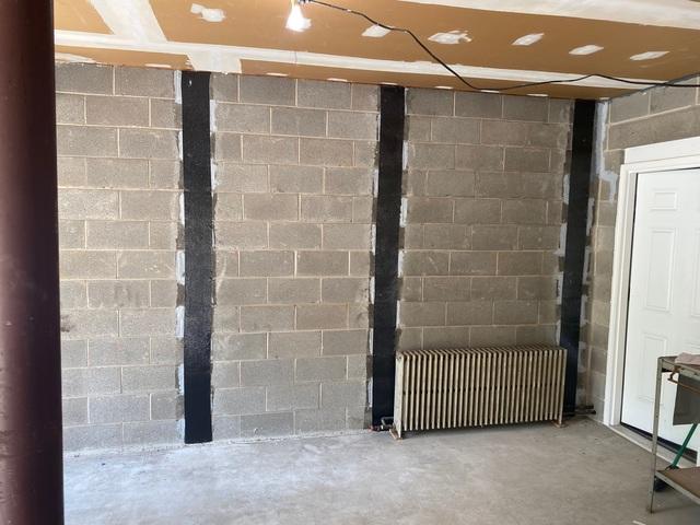 The Carbon Armor Straps are applied to the wall using an epoxy resin. The system is overall ten times stronger than steel and will prevent the walls from bowing further.