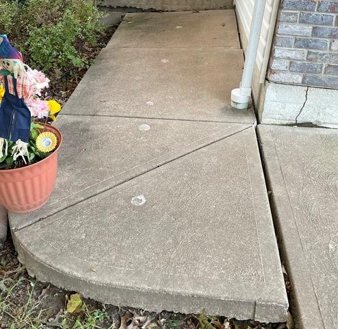 This sidewalk is uneven and crooked due to the slabs settling.