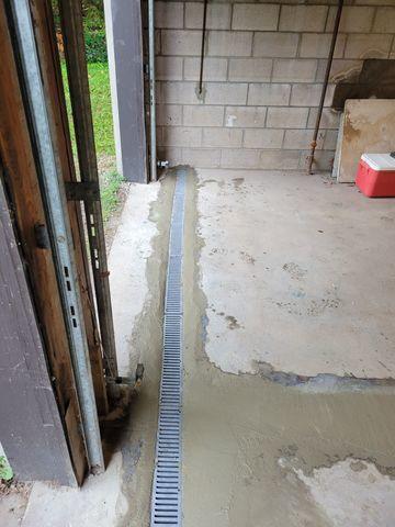 Extra large floor drain is added at the garage door