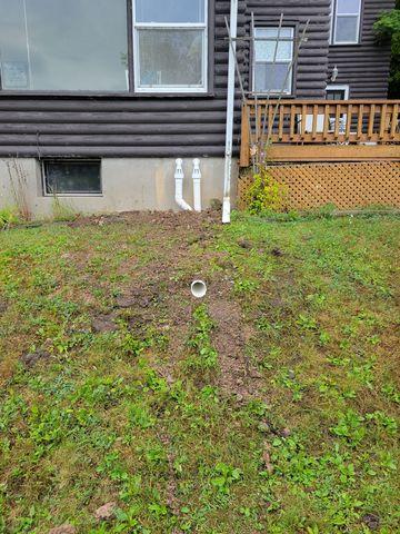 The discharge lines exits the house and neatly put under the ground to exit on a hill.