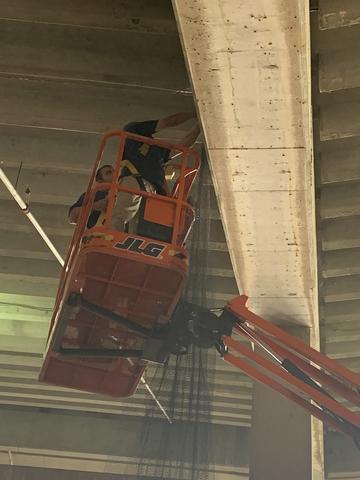 In order make sure the bird netting is secured, we're using a stainless steel cable with net spikes and are anchoring it into the walls.