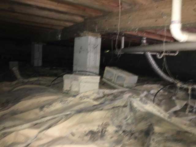 We began our project by installing 106 linear feet of drain tile around perimeter of crawlspace and tied into a SuperSump with a Zoeller M98 sump pump. We discharged that plumbing to the outside through an IceGuard that runs to a 15 foot underground downspout. To combat the heavy areas of mold, we sprayed Mold-X.

To help manage moisture and humidity, we installed a CleanSpace Encapsulation System over exterior walls, across the floor, and around existing pilasters. The encapsulation system was buttoned along the walls, with all seams on the walls and floor overlapped, then sealed with urethane, and secured with industrial tape. 

To help support the structure, we installed a new beam on existing support columns and pocket. We also sistered floor joists with new lumber. 

Finally, we installed an AprilAire E100 and drained that into the SuperSump.