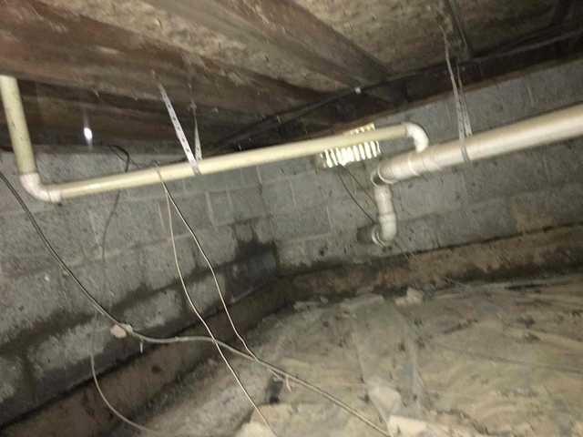 We began our project by installing 106 linear feet of drain tile around perimeter of crawlspace and tied into a SuperSump with a Zoeller M98 sump pump. We discharged that plumbing to the outside through an IceGuard that runs to a 15 foot underground downspout. To combat the heavy areas of mold, we sprayed Mold-X.

To help manage moisture and humidity, we installed a CleanSpace Encapsulation System over exterior walls, across the floor, and around existing pilasters. The encapsulation system was buttoned along the walls, with all seams on the walls and floor overlapped, then sealed with urethane, and secured with industrial tape. 

To help support the structure, we installed a new beam on existing support columns and pocket. We also sistered floor joists with new lumber. 

Finally, we installed an AprilAire E100 and drained that into the SuperSump.