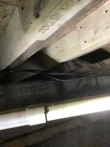 We began our project by installing 106 linear feet of drain tile around perimeter of crawlspace and tied into a SuperSump with a Zoeller M98 sump pump. We discharged that plumbing to the outside through an IceGuard that runs to a 15 foot underground downspout. To combat the heavy areas of mold, we sprayed Mold-X.

To help manage moisture and humidity, we installed a CleanSpace Encapsulation System over exterior walls, across the floor, and around existing pilasters. The encapsulation system was buttoned along the walls, with all seams on the walls and floor overlapped, then sealed with urethane, and secured with industrial tape. 

To help support the structure, we installed a new beam on existing support columns and pocket. We also sistered floor joists with new lumber. 

Finally, we installed an AprilAire E100 and drained that into the SuperSump.