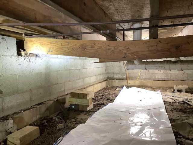 We began our project by installing 106 linear feet of drain tile around perimeter of crawlspace and tied into a SuperSump with a Zoeller M98 sump pump. We discharged that plumbing to the outside through an IceGuard that runs to a 15 foot underground downspout. To combat the heavy areas of mold, we sprayed Mold-X.

To help manage moisture and humidity, we installed a CleanSpace Encapsulation System over exterior walls, across the floor, and around existing pilasters. The encapsulation system was buttoned along the walls, with all seams on the walls and floor overlapped, then sealed with urethane, and secured with industrial tape. 

To help support the structure, we installed a new beam on existing support columns and pocket. We also sistered floor joists with new lumber. 

Finally, we installed an AprilAire E100 and drained that into the SuperSump.