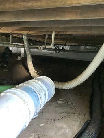 We began our project by installing 106 linear feet of drain tile around perimeter of crawlspace and tied into a SuperSump with a Zoeller M98 sump pump. We discharged that plumbing to the outside through an IceGuard that runs to a 15 foot underground downspout. To combat the heavy areas of mold, we sprayed Mold-X.

To help manage moisture and humidity, we installed a CleanSpace Encapsulation System over exterior walls, across the floor, and around existing pilasters. The encapsulation system was buttoned along the walls, with all seams on the walls and floor overlapped, then sealed with urethane, and secured with industrial tape. 

To help support the structure, we installed a new beam on existing support columns and pocket. We also sistered floor joists with new lumber. 

Finally, we installed an AprilAire E100 and drained that into the SuperSump.