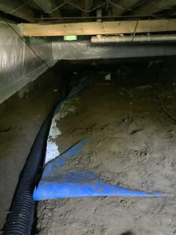 We began our project by installing 106 linear feet of drain tile around perimeter of crawlspace and tied into a SuperSump with a Zoeller M98 sump pump. We discharged that plumbing to the outside through an IceGuard that runs to a 15 foot underground downspout. To combat the heavy areas of mold, we sprayed Mold-X.

To help manage moisture and humidity, we installed a CleanSpace Encapsulation System over exterior walls, across the floor, and around existing pilasters. The encapsulation system was buttoned along the walls, with all seams on the walls and floor overlapped, then sealed with urethane, and secured with industrial tape. 

To help support the structure, we installed a new beam on existing support columns and pocket. We also sistered floor joists with new lumber. 

Finally, we installed an AprilAire E100 and drained that into the SuperSump.