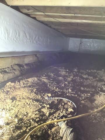 We began our project by installing 106 linear feet of drain tile around perimeter of crawlspace and tied into a SuperSump with a Zoeller M98 sump pump. We discharged that plumbing to the outside through an IceGuard that runs to a 15 foot underground downspout. To combat the heavy areas of mold, we sprayed Mold-X.

To help manage moisture and humidity, we installed a CleanSpace Encapsulation System over exterior walls, across the floor, and around existing pilasters. The encapsulation system was buttoned along the walls, with all seams on the walls and floor overlapped, then sealed with urethane, and secured with industrial tape. 

To help support the structure, we installed a new beam on existing support columns and pocket. We also sistered floor joists with new lumber. 

Finally, we installed an AprilAire E100 and drained that into the SuperSump.