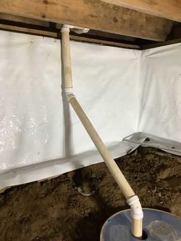 We began our project by installing 106 linear feet of drain tile around perimeter of crawlspace and tied into a SuperSump with a Zoeller M98 sump pump. We discharged that plumbing to the outside through an IceGuard that runs to a 15 foot underground downspout. To combat the heavy areas of mold, we sprayed Mold-X.

To help manage moisture and humidity, we installed a CleanSpace Encapsulation System over exterior walls, across the floor, and around existing pilasters. The encapsulation system was buttoned along the walls, with all seams on the walls and floor overlapped, then sealed with urethane, and secured with industrial tape. 

To help support the structure, we installed a new beam on existing support columns and pocket. We also sistered floor joists with new lumber. 

Finally, we installed an AprilAire E100 and drained that into the SuperSump.