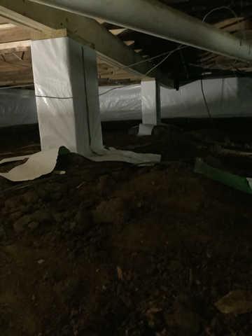 We began our project by installing 106 linear feet of drain tile around perimeter of crawlspace and tied into a SuperSump with a Zoeller M98 sump pump. We discharged that plumbing to the outside through an IceGuard that runs to a 15 foot underground downspout. To combat the heavy areas of mold, we sprayed Mold-X.

To help manage moisture and humidity, we installed a CleanSpace Encapsulation System over exterior walls, across the floor, and around existing pilasters. The encapsulation system was buttoned along the walls, with all seams on the walls and floor overlapped, then sealed with urethane, and secured with industrial tape. 

To help support the structure, we installed a new beam on existing support columns and pocket. We also sistered floor joists with new lumber. 

Finally, we installed an AprilAire E100 and drained that into the SuperSump.