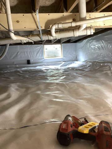 We began our project by installing 106 linear feet of drain tile around perimeter of crawlspace and tied into a SuperSump with a Zoeller M98 sump pump. We discharged that plumbing to the outside through an IceGuard that runs to a 15 foot underground downspout. To combat the heavy areas of mold, we sprayed Mold-X.

To help manage moisture and humidity, we installed a CleanSpace Encapsulation System over exterior walls, across the floor, and around existing pilasters. The encapsulation system was buttoned along the walls, with all seams on the walls and floor overlapped, then sealed with urethane, and secured with industrial tape. 

To help support the structure, we installed a new beam on existing support columns and pocket. We also sistered floor joists with new lumber. 

Finally, we installed an AprilAire E100 and drained that into the SuperSump.