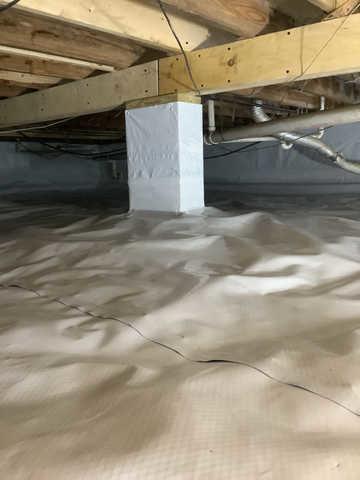 We began our project by installing 106 linear feet of drain tile around perimeter of crawlspace and tied into a SuperSump with a Zoeller M98 sump pump. We discharged that plumbing to the outside through an IceGuard that runs to a 15 foot underground downspout. To combat the heavy areas of mold, we sprayed Mold-X.

To help manage moisture and humidity, we installed a CleanSpace Encapsulation System over exterior walls, across the floor, and around existing pilasters. The encapsulation system was buttoned along the walls, with all seams on the walls and floor overlapped, then sealed with urethane, and secured with industrial tape. 

To help support the structure, we installed a new beam on existing support columns and pocket. We also sistered floor joists with new lumber. 

Finally, we installed an AprilAire E100 and drained that into the SuperSump.