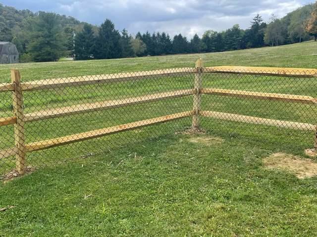 3 Rail Split Rail with Chain Link on the inside Natural / Brown Pressure Treated Wood / Chain Link / (2) 4' gates / (2) 8' double gate / Bottom Tension wire / Brown Chain Link Added to the inside of the split rail