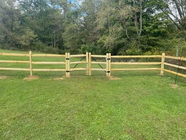 3 Rail Split Rail with Chain Link on the inside Natural / Brown Pressure Treated Wood / Chain Link / (2) 4' gates / (2) 8' double gate / Bottom Tension wire / Brown Chain Link Added to the inside of the split rail