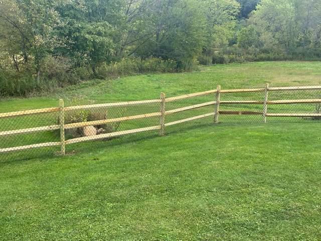 3 Rail Split Rail with Chain Link on the inside Natural / Brown Pressure Treated Wood / Chain Link / (2) 4' gates / (2) 8' double gate / Bottom Tension wire / Brown Chain Link Added to the inside of the split rail