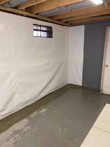 Our team installed this vapor barrier along the wall which will keep the basement safe from mold and moisture damage.