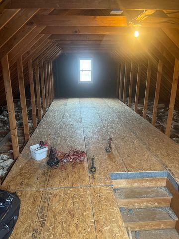 With the floors insulated and covered in plywood, the deck walls would be constructed next and then the space would be filled with Tru Soft Cellulose Insulation.  The panel insulation under the floor can be seen at the top step to the attic.