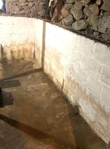 Water at the base of the foundation walls was collecting and sitting.  This lead to a musty smell in the basement.