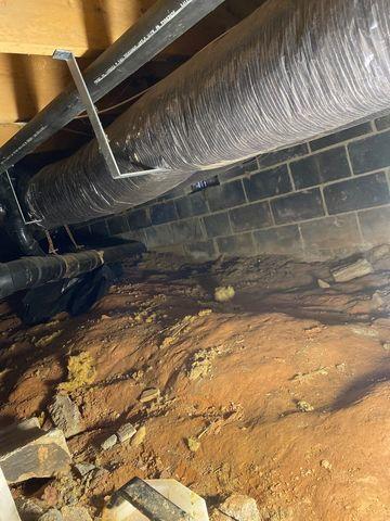 An open air vent in the wall was allowing external air and moisture into the crawl space.  The dirt floors allowed moisture to settle and make the space humid.