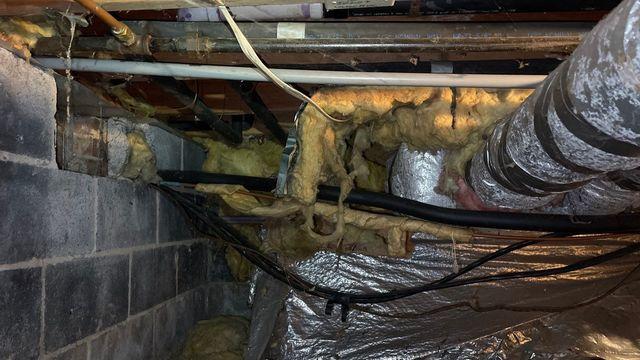 The old insulation intended to insulate the ceiling of the crawl space and keep the floors above warm was not work due to having fallen loose.  This would later be removed and insulation would be installed on the walls rather than the ceiling.