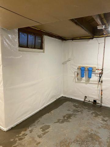 Cleanspace helps with many issues in a basement or crawlspace. Here it is helping collect water coming in from the cracks in the walls, and sends it to the WaterGuard under the wet concrete in this photo. These systems work well together, because the Cleanspace is waterproof, and the WaterGuard is a direct channel to the sump pump that then discharges the water out of the home.