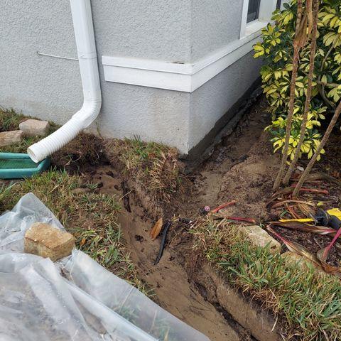 LRE got to work around the exterior of this home, digging trenches that would ultimately divert water away from the foundation and out into the yard and toward the street.