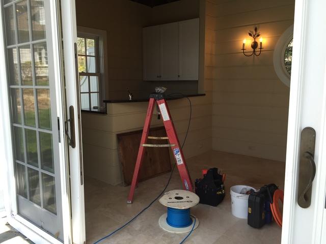 Wiring the speakers and subwoofer from the pool house. 