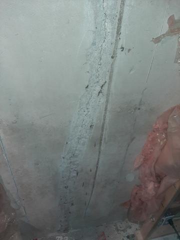 `First step in this case is to remove the old repair by grinding down the wall.