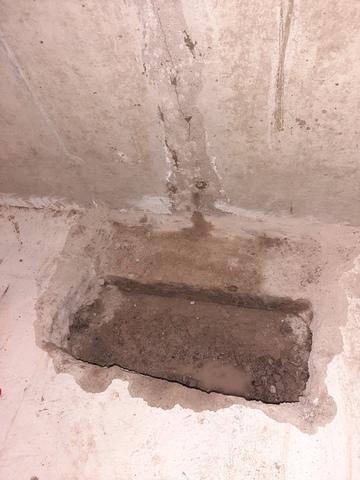 The crack does ot stop at the floor . In fact it goes all the way to the footing. We open the floor and expose the footing and the gravel bed below.