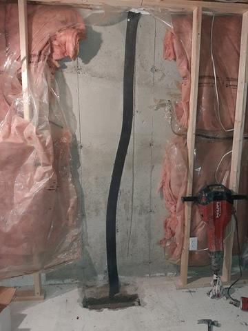 Over the bead of sealant, an open cell drainage foam is applied. IF any moisture ever gets past the sealant, this is used as second line of defense to direct it down to the gravel bed beneath the floor slab.