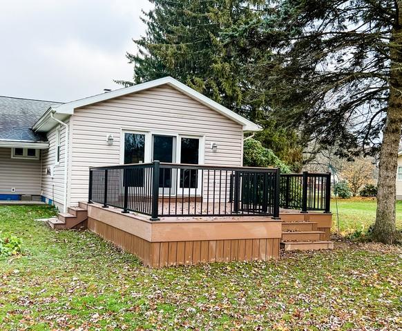 A nice large deck welcoming their large sliding glass door to the backyard.