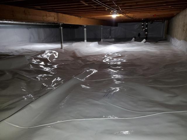 CleanSpace liner on top of dimpled membrane & walls of crawl space