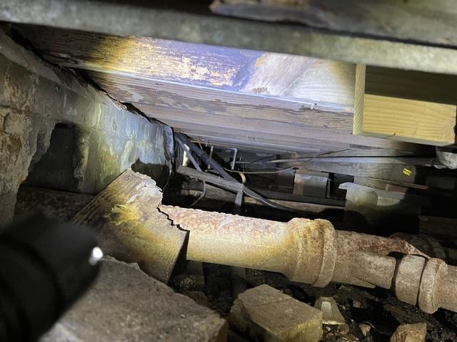 The crawlspace of this home suffered severe water damage due to moisture intrusion, which caused mold and wood decay.